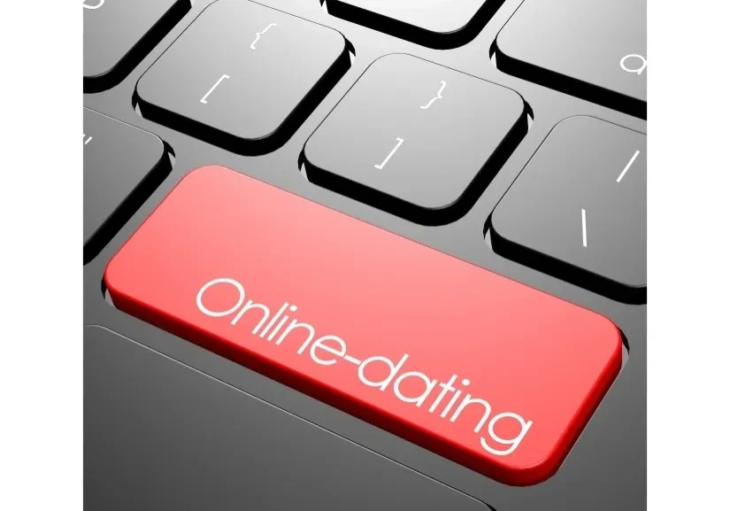 A red button on top of a keyboard that says " online-dating ".